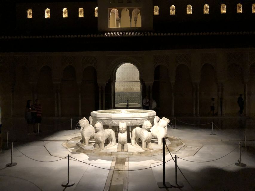 Granada: The Alhambra and Nasrid Palaces Guided Night Tour - The Palace of the Lions under night lighting