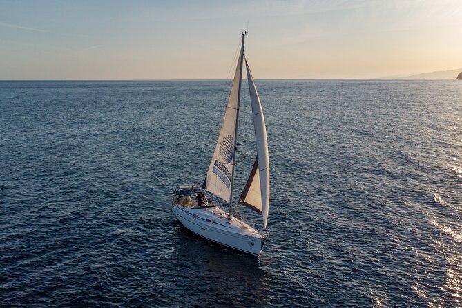 Sailing at sunset along the cliffs of Maro-Compartida - A Bavaria 37 makes the ride feel personal