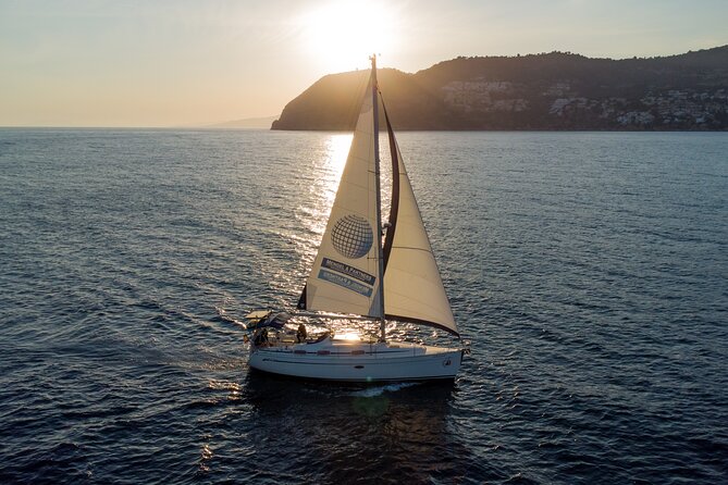 Sailing at sunset along the cliffs of Maro-Compartida - Music, catering, and a simple toast